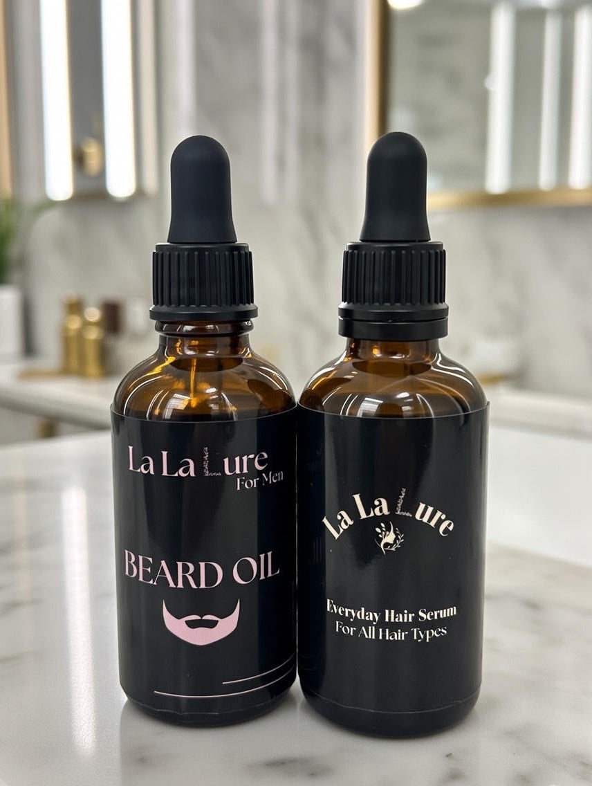 Two bottles of La La Lure hair care products on a marble surface.